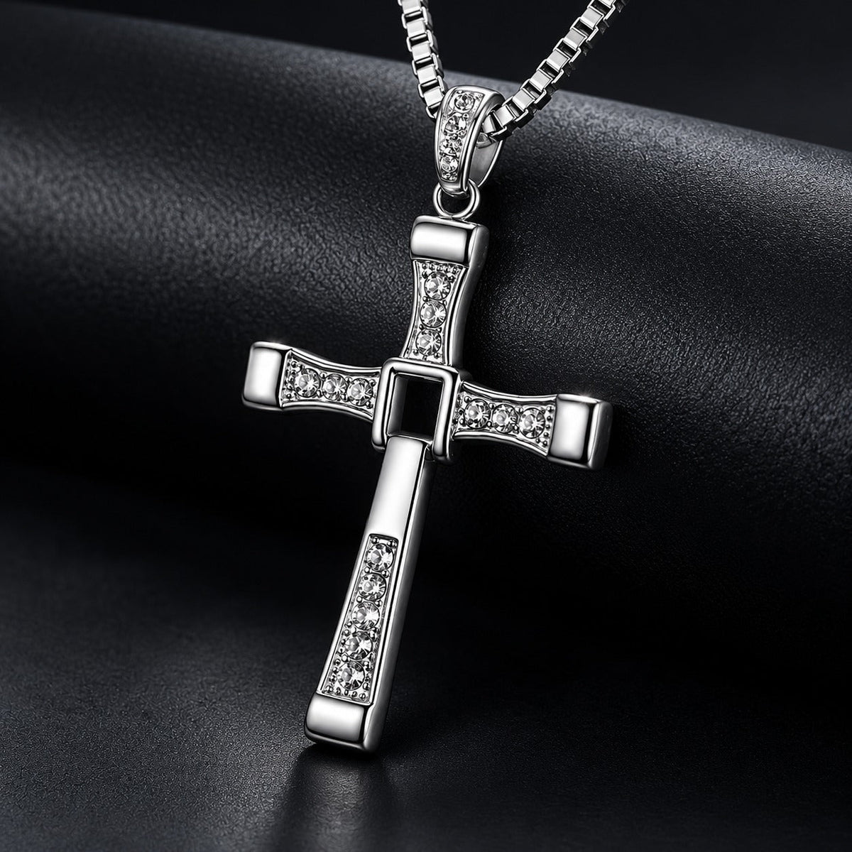 Close-up of the Fidelink cross pendant on a dark background