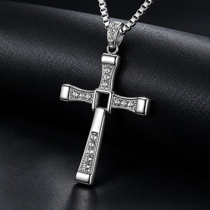 Close-up of the Fidelink cross pendant on a dark background